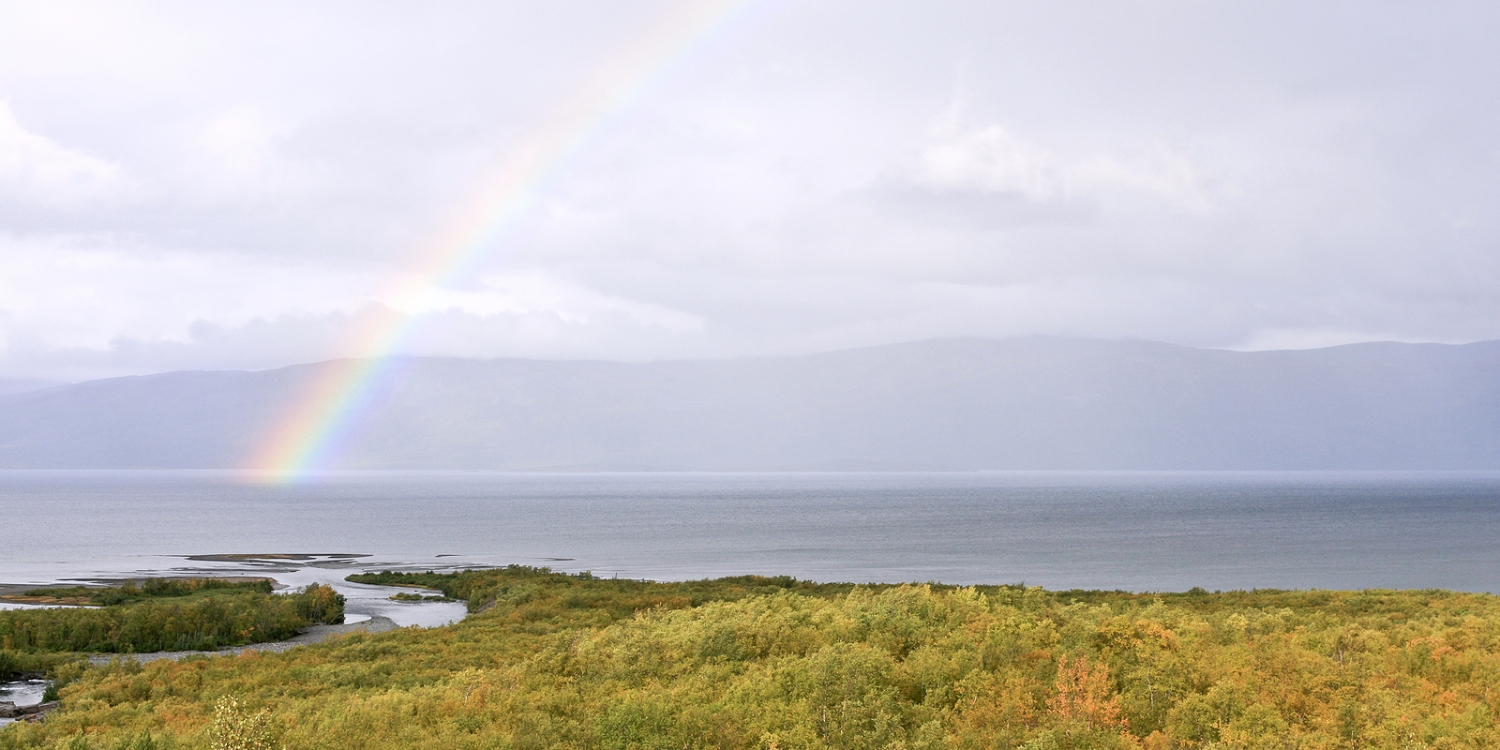 Rainbow over a mountain lake.